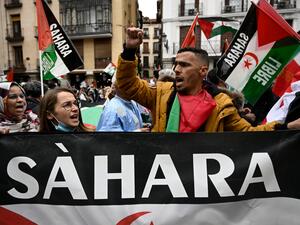 Demonstrators wave Western Sahara flags during a protest against the Spanish government support for Morocco's autonomy plan for Western Sahara, in Madrid, on March 26, 2022. (Photo by Pierre-Philippe MARCOU / AFP) tourism ties