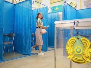 A woman leaves a polling booth on her way to cast his ballot at a polling station as part of the vote for a referendum to overhaul the constitution in Almaty on June 5, 2022. (Photo by Ruslan PRYANIKOV / AFP) Kazakhstan starts holding referendum on constitutional reforms
