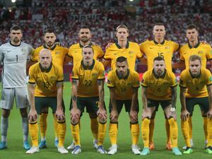 Australia's players pose for a group picture ahead of the FIFA World Cup 2022 inter-confederation play-offs match between Australia and Peru on June 13, 2022, at the Ahmed bin Ali Stadium in the Qatari city of Ar-Rayyan. (Photo by MUSTAFA ABUMUNES / AFP)