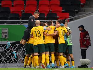 Australia's players celebrate after scoring a goal during the FIFA World Cup 2022 play-off qualifier football match between UAE and Australia at Ahmad bin Ali stadium in Qatar's Ar-Rayyan on June 7, 2022. (Photo by KARIM JAAFAR / AFP)