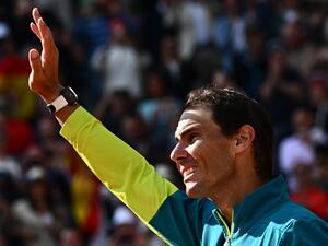 Spain's Rafael Nadal waves as he celebrates after victory over Norway's Casper Ruud during their men's singles final match on day fifteen of the Roland-Garros Open tennis tournament at the Court Philippe-Chatrier in Paris on June 5, 2022. (Photo by Anne-Christine POUJOULAT / AFP)