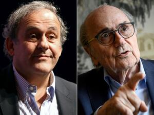 Michel Platini and Sepp Blatter (Photo by VALERY HACHE and Fabrice COFFRINI / AFP)