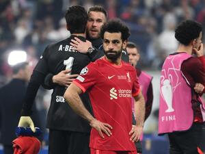 Liverpool's Egyptian midfielder Mohamed Salah (C) reacts after Real Madrid's victory in the UEFA Champions League final football match between Liverpool and Real Madrid at the Stade de France in Saint-Denis, north of Paris, on May 28, 2022. (Photo by FRANCK FIFE / AFP)