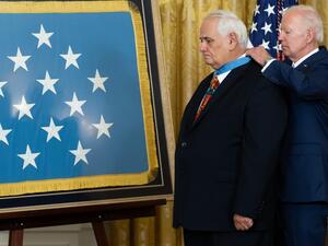 US President Joe Biden awards the Medal of Honor to retired US Army Specialist Five Dwight W. Birdwell for his actions in the Vietnam War, during a ceremony in the East Room of the White House in Washington, DC, July 5, 2022. (Photo by SAUL LOEB / AFP) medal backward