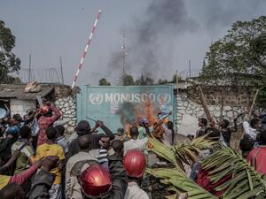 Protesters set fire in front of United Nations Mission for the Stabilisation of Congo (MONUSCO) Headquarters in Goma, on July 25, 2022. (Photo by GLODY MURHABAZI / AFP) Anti-UN protests