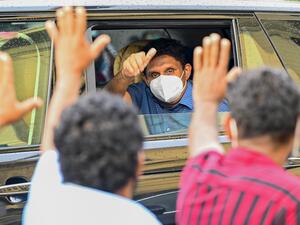 Sri Lanka's main opposition leader Sajith Premadasa waves from a car to supporters during a demonstration to denounce the shortage of cooking gas, sugar, kerosene oil and a few other commodities as the country faces a major foreign exchange crisis, in Colombo on November 16, 2021. (Photo by ISHARA S. KODIKARA / AFP) Sri Lanka