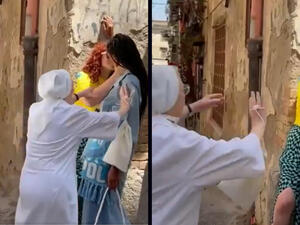 Italian nun in white seen pulling apart two girls who were kissing in the street. (Twitter/ Video screenshot) Italian nun