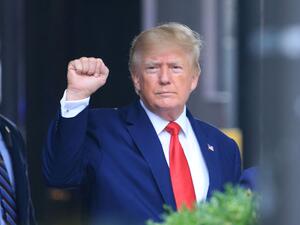 In this file photo taken on August 10, 2022 former US President Donald Trump raises his fist while walking to a vehicle outside of Trump Tower in New York City. (Photo by STRINGER / AFP) Donald Trump
