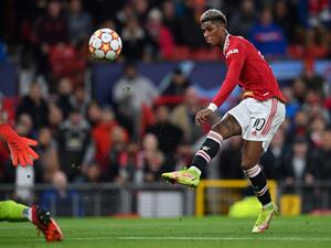 Manchester United's English striker Marcus Rashford scores his team's first goal during the UEFA Champions league group F football match between Manchester United and Atalanta at Old Trafford stadium in Manchester, north west England, on October 20, 2021. (Photo by Paul ELLIS / AFP)