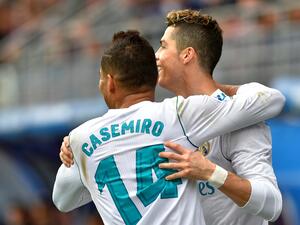 Real Madrid's Portuguese forward Cristiano Ronaldo (R) celebrates with Real Madrid's Brazilian midfielder Casemiro after scoring a goal during the Spanish league football match between Eibar and Real Madrid at the Ipurua stadium in Eibar on March 10, 2018. (Photo by ANDER GILLENEA / AFP)