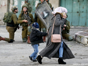 Palestinian woman, Israeli soldiers in Hebron