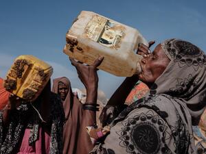 In this file photo taken on February 13, 2022 Hawa Mohamed Isack (R), 60, drinks water at a water distribution point at Muuri camp, one of the 500 camps for internally displaced persons (IDPs) in town, in Baidoa, Somalia. (Photo by YASUYOSHI CHIBA / AFP) Drought Funds