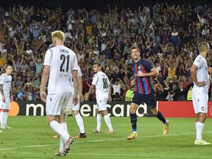 Barcelona's Polish forward Robert Lewandowski (2nd-L) celebrates after scoring his team's third goal during the UEFA Champions League Group C first-leg football match between FC Barcelona and Viktoria Plzen, at the Camp Nou stadium in Barcelona on September 7, 2022. (Photo by Pau BARRENA / AFP)