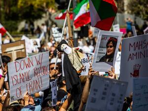 A woman holds a dummy doll representing Iran's Supreme Leader Ali Khamenei in a noose during a protest for Mahsa Amini who died in custody of Iran's morality police, in front of the Los Angeles City Hall, Los Angeles, California, on October 1, 2022. (Photo by Apu GOMES / AFP) violent protests