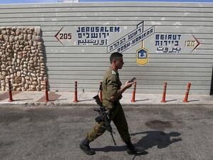 An Israeli soldier walks at the Rosh Hanikra border crossing between Lebanon and Israel, on October 7, 2022. (Photo by JALAA MAREY / AFP) gas deal