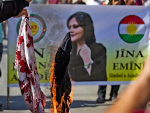 Demonstrators burn headscarves during a solidarity protest organised by the "Kurdish National Council" Syrian-Kurdish political bloc, against the death of 22-year-old Mahsa Amini. (Photo by Delil SOULEIMAN / AFP) Mahsa Amini