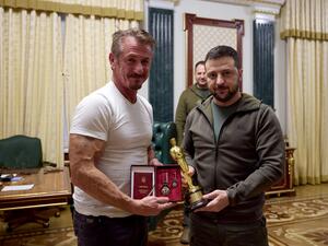 Ukrainian President Volodymyr Zelensky (R) posing with US actor Sean Penn (L) after receiving latter's Oscar statuette and handing him the Order of Merit, III degree during their meeting in Kyiv. (Photo by UKRAINIAN PRESIDENTIAL PRESS SERVICE / AFP) Ukrainian President