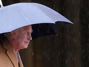 Britain's King Charles III shelters from the rain beneath an umbrella during a visit to York Minster in York, northern England on November 9, 2022 during a two-day tour of Yorkshire. (Photo by Danny Lawson / POOL / AFP) King Charles III