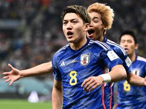 Japan's midfielder #08 Ritsu Doan celebrates scoring his team's first goal during the Qatar 2022 World Cup Group E football match between Germany and Japan at the Khalifa International Stadium in Doha on November 23, 2022. (Photo by Jewel SAMAD / AFP)