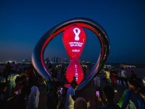 People gather for photos around the World Cup countdown clock in Doha on November 14, 2022, ahead of the Qatar 2022 World Cup football tournament. (Photo by ANDREJ ISAKOVIC / AFP)