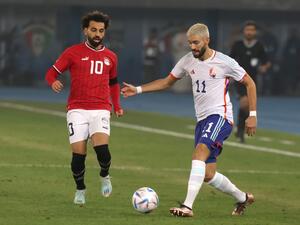 Egypt's forward Mohamed Salah (L) and Belgium's midfielder Yannick Carrasco vie for the ball during the friendly football match between Belgium and Egypt at the Jaber Al-Ahmad Stadium in Kuwait City on November 18, 2022. (Photo by Yasser Al-Zayyat / AFP)