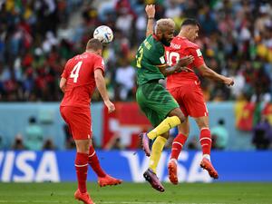 Cameroon's forward #13 Eric Maxim Choupo-Moting (C) fights for the ball with Switzerland's defender #04 Nico Elvedi (L) and Switzerland's midfielder #10 Granit Xhaka during the Qatar 2022 World Cup Group G football match between Switzerland and Cameroon at the Al-Janoub Stadium in Al-Wakrah, south of Doha on November 24, 2022. (Photo by Fabrice COFFRINI / AFP)