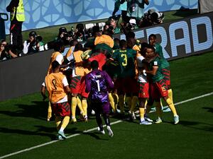 Cameroon's players celebrate after scoring a goal during the Qatar 2022 World Cup Group G football match between Cameroon and Serbia at the Al-Janoub Stadium in Al-Wakrah, south of Doha on November 28, 2022. (Photo by Anne-Christine POUJOULAT / AFP)