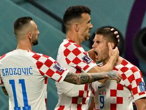 Croatia's forward #09 Andrej Kramaric celebrates with Croatia's midfielder #11 Marcelo Brozovic and Croatia's midfielder #04 Ivan Perisic after scoring his team's first goal during the Qatar 2022 World Cup Group F football match between Croatia and Canada at the Khalifa International Stadium in Doha on November 27, 2022. (Photo by Patrick T. FALLON / AFP)