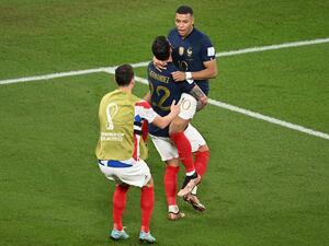  France's defender #22 Theo Hernandez hugs France's forward #10 Kylian Mbappe after scoring his team's first goal during the Qatar 2022 World Cup Group D football match between France and Denmark at Stadium 974 in Doha on November 26, 2022. (Photo by Anne-Christine POUJOULAT / AFP)