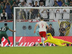 Poland's goalkeeper #01 Wojciech Szczesny stops a penalty by Saudi Arabia's midfielder #10 Salem Al-Dawsari during the Qatar 2022 World Cup Group C football match between Poland and Saudi Arabia at the Education City Stadium in Al-Rayyan, west of Doha on November 26, 2022. (Photo by Odd ANDERSEN / AFP)