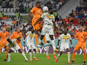 Netherlands' defender #22 Denzel Dumfries (L) and Senegal's forward #09 Boulaye Dia jump for the ball during the Qatar 2022 World Cup Group A football match between Senegal and the Netherlands at the Al-Thumama Stadium in Doha on November 21, 2022. (Photo by Alberto PIZZOLI / AFP)