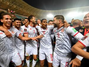 Tunisia's players celebrate qualifying to the 2022 Qatar World Cup African Qualifiers football match between Tunisia and Mali at the Hamadi Agrebi Olympic stadium in the city of Rades on March 29, 2022. Tunisia secured a place at the 2022 World Cup in Qatar despite being held 0-0 at home by Mali in the second leg of an African play-off. (Photo by FETHI BELAID / AFP)
