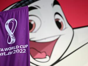 A FIFA banner is displayed in front of a poster of Qatar 2022 mascot La'eeb in Doha on November 7, 2022, ahead of the Qatar 2022 FIFA World Cup football tournament. (Photo by Gabriel BOUYS / AFP)