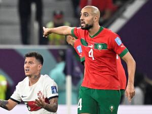 Portugal's midfielder #25 Otavio (L) and Morocco's midfielder #04 Sofyan Amrabat (R) react during the Qatar 2022 World Cup quarter-final football match between Morocco and Portugal at the Al-Thumama Stadium in Doha on December 10, 2022. (Photo by PATRICIA DE MELO MOREIRA / AFP)