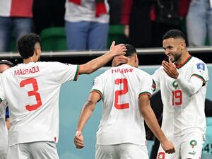 Morocco's forward #19 Youssef En-Nesyri (R) celebrates with Morocco's defender #02 Achraf Hakimi (C) and Morocco's defender #03 Noussair Mazraoui after he scored his team's first goal during the Qatar 2022 World Cup Group F football match between Canada and Morocco at the Al-Thumama Stadium in Doha on December 1, 2022. (Photo by NATALIA KOLESNIKOVA / AFP)