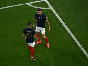 France's forward #09 Olivier Giroud celebrates with France's forward #10 Kylian Mbappe after scoring his team's first goal during the Qatar 2022 World Cup round of 16 football match between France and Poland at the Al-Thumama Stadium in Doha on December 4, 2022. (Photo by MANAN VATSYAYANA / AFP)