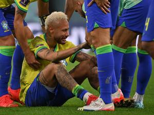 Brazil's forward #10 Neymar is consoled by teammates after they lost the Qatar 2022 World Cup quarter-final football match between Croatia and Brazil at Education City Stadium in Al-Rayyan, west of Doha, on December 9, 2022. (Photo by NELSON ALMEIDA / AFP)