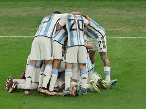 Argentina's midfielder #11 Angel Di Maria (C) celebrates with teammates after scoring his team's second goal during the Qatar 2022 World Cup final football match between Argentina and France at Lusail Stadium in Lusail, north of Doha on December 18, 2022. (Photo by JACK GUEZ / AFP)