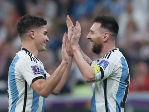 Argentina's forward #09 Julian Alvarez (L) celebrates scoring his team's third goal with Argentina's forward #10 Lionel Messi during the Qatar 2022 World Cup football semi-final match between Argentina and Croatia at Lusail Stadium in Lusail, north of Doha on December 13, 2022. (Photo by Giuseppe CACACE / AFP)