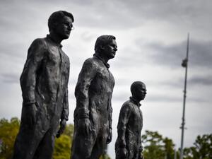 A picture of the installation "Anything to Say?", a bronze sculpture and art installation by Italian sculptor Davide Dormino representing whistleblowers (from L) Edward Snowden, Julian Assange and Chelsea Manning is seen on the Place des Nations next to the United Nations Offices in Geneva, on September 15, 2015. AFP PHOTO / FABRICE COFFRINI Elon Musk