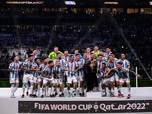 Argentina's forward #10 Lionel Messi lifts the FIFA World Cup Trophy as he celebrates with teammates winning the Qatar 2022 World Cup final football match between Argentina and France at Lusail Stadium in Lusail, north of Doha on December 18, 2022. (Photo by Kirill KUDRYAVTSEV / AFP)