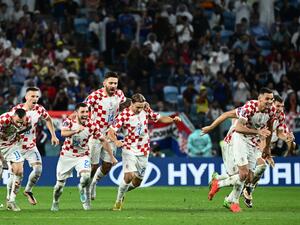 Croatia players celebrate after they won the Qatar 2022 World Cup round of 16 football match between Japan and Croatia at the Al-Janoub Stadium in Al-Wakrah, south of Doha on December 5, 2022. (Photo by Jewel SAMAD / AFP)
