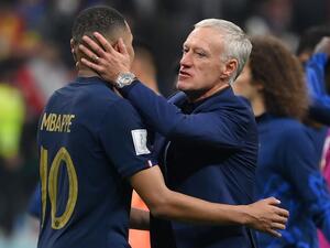 France's coach Didier Deschamps embraces France's forward #10 Kylian Mbappe at the end of the Qatar 2022 World Cup semi-final football match between France and Morocco at the Al-Bayt Stadium in Al Khor, north of Doha on December 14, 2022. (Photo by FRANCK FIFE / AFP)