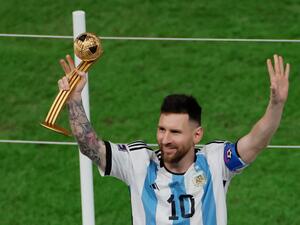Argentina's forward #10 Lionel Messi gestures after receiving the Golden Ball award during the Qatar 2022 World Cup trophy ceremony after the football final match between Argentina and France at Lusail Stadium in Lusail, north of Doha on December 18, 2022. (Photo by Odd ANDERSEN / AFP)