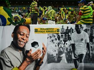 Brazil legend Pele is displayed on large banners near the crowd during the Qatar 2022 World Cup Group G football match between Cameroon and Brazil at the Lusail Stadium in Lusail, north of Doha on December 2, 2022. (Photo by Jewel SAMAD / AFP)