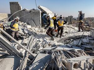Syrian rescue teams inspect the damage at the site of an alleged US-led coalition drone strike in the opposition-held city of al-Bab. (Photo by Bakr ALKASEM / AFP) building collapse