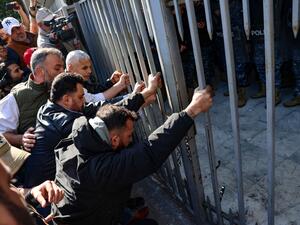 Relatives of victims of the 2020 Beirut port explosion, push against the entrance gate of the palace of justice in the Lebanese capital, during a rally to support the judge investigating the disaster, on Jan. 26. (Photo by Joseph EID / AFP) Beirut blast