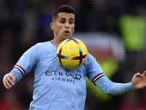 Manchester City's Portuguese defender Joao Cancelo controls the ball during the English Premier League football match between Manchester United and Manchester City at Old Trafford in Manchester, north west England, on January 14, 2023. (Photo by Oli SCARFF / AFP)
