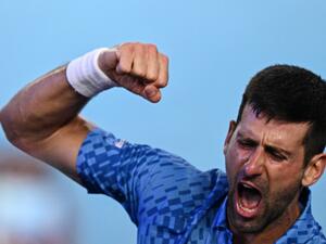 Serbia's Novak Djokovic celebrates his victory against Greece's Stefanos Tsitsipas during the men's singles final on day fourteen of the Australian Open tennis tournament in Melbourne on January 29, 2023. (Photo by ANTHONY WALLACE / AFP)