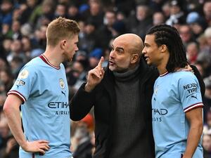 Manchester City's Spanish manager Pep Guardiola (C) speaks with Manchester City's Belgian midfielder Kevin De Bruyne (L) and Manchester City's Dutch defender Nathan Ake (R) during the English Premier League football match between Manchester City and Wolverhampton Wanderers  at the Etihad Stadium in Manchester, north west England, on January 22, 2023. (Photo by Paul ELLIS / AFP)